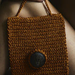 Handmade crochet bag with seashell adornment 