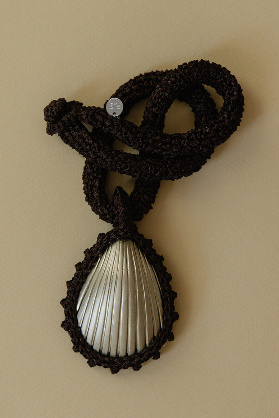 Hand crocheted necklace with a silver-plated bronze seashell pendant